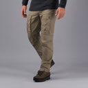 Person wearing sand Torv waxed trekking trousers on a grey background